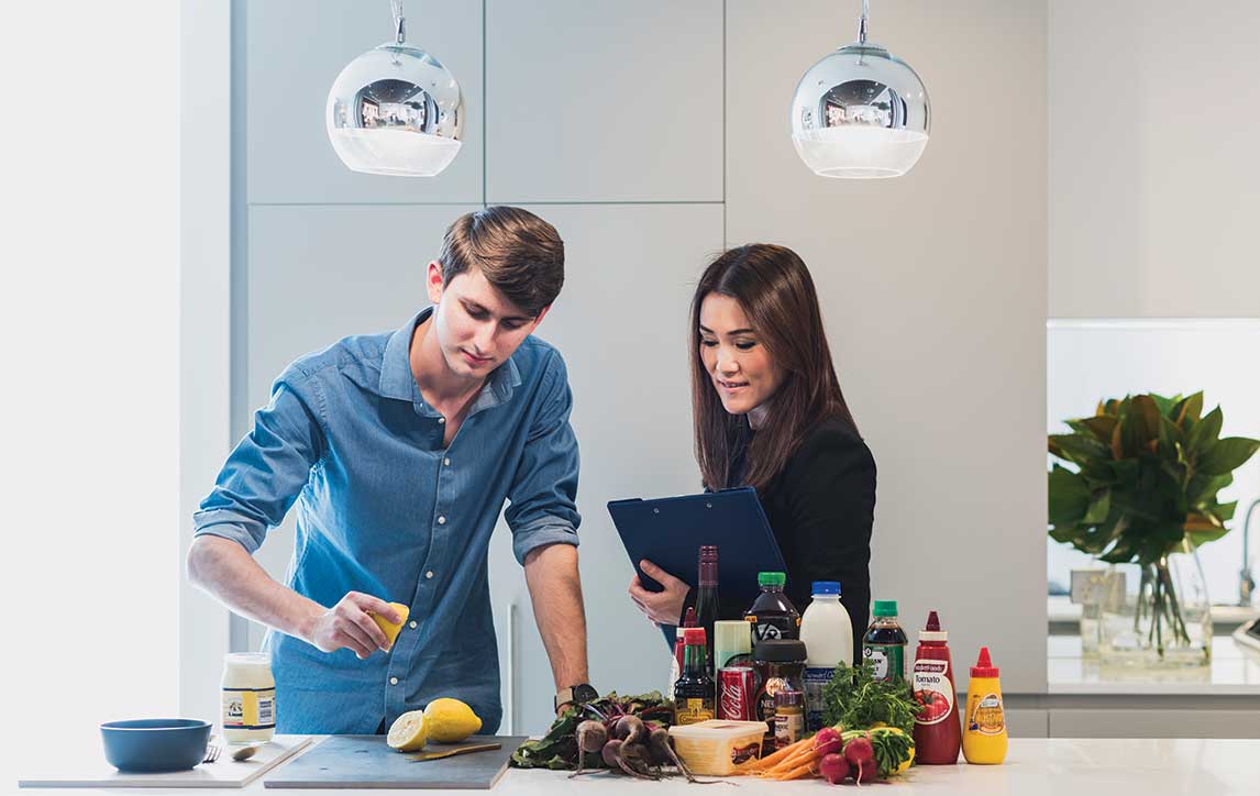 Mirvac employees testing materials in kitchen